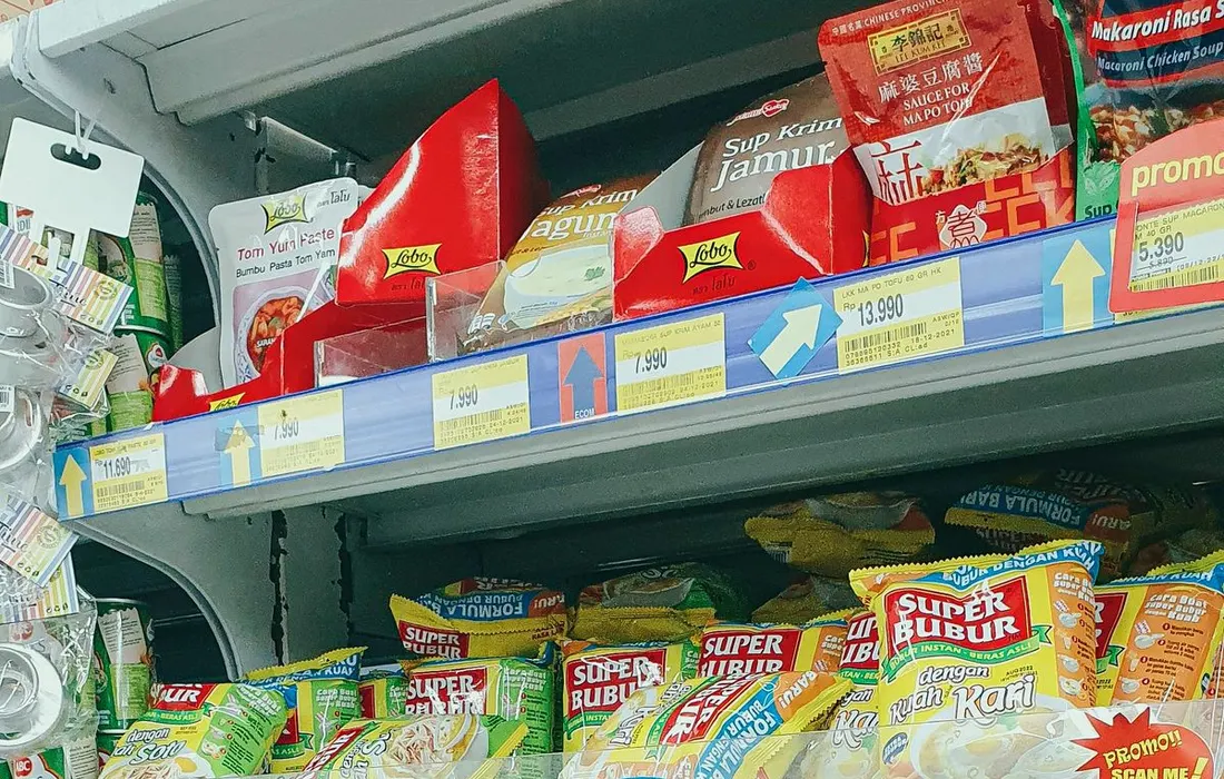 Packaged groceries arranged on shop shelves.