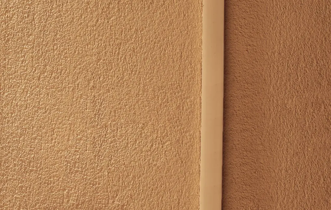 An indoor hygrometer mounted on a textured wall.
