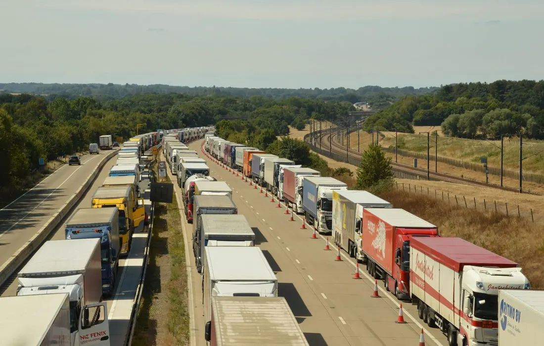 An aerial view of lorries and other traffic on a highway in England.