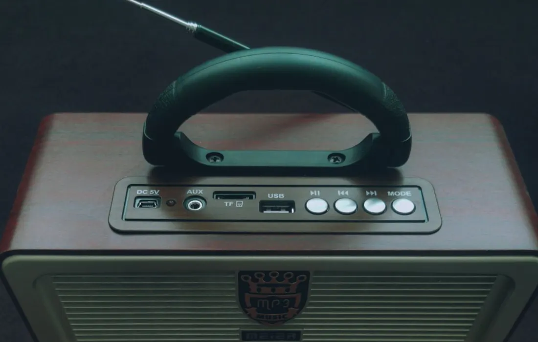 A close view of a portable radio with an aerial and controls.
