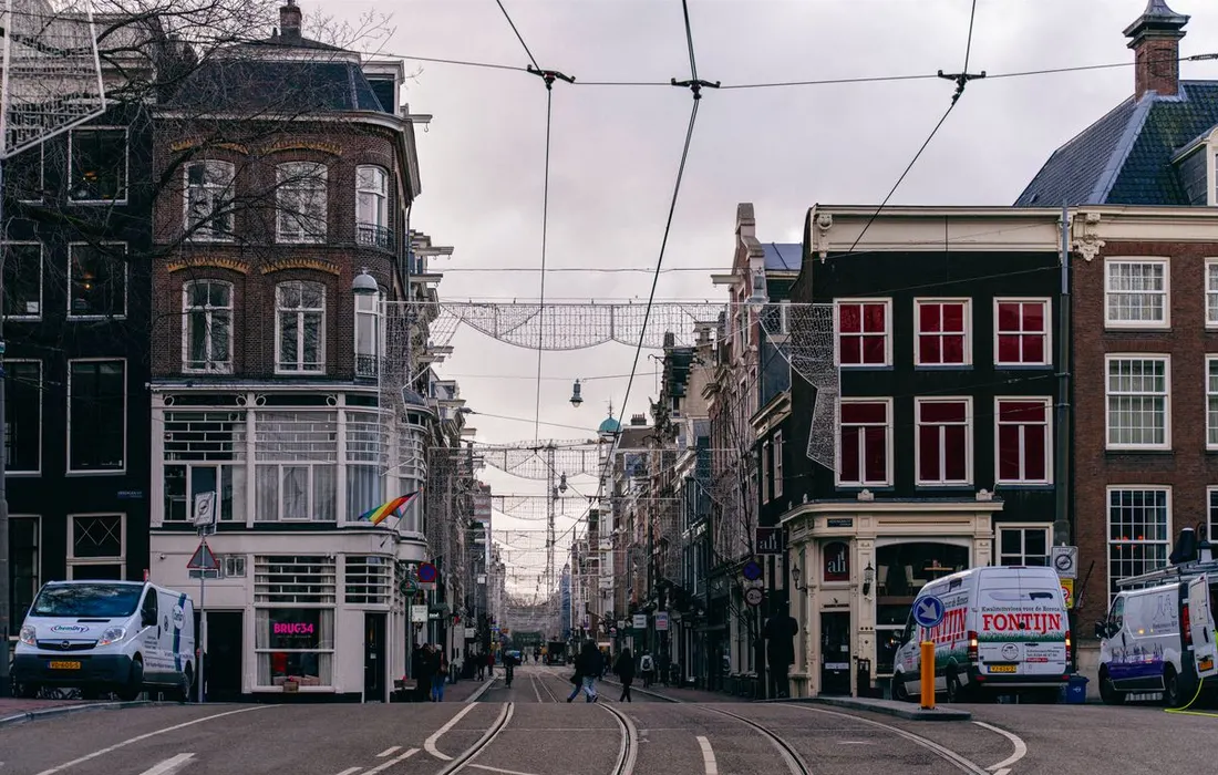 A street with historic buildings and tram tracks.