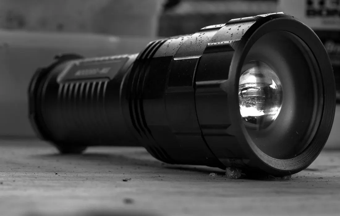 A black-and-white close-up of an electric torch.