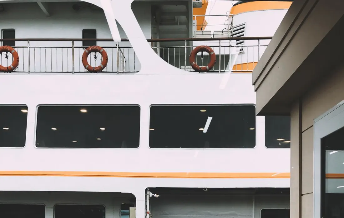 A ferry moored at a port on a rainy day.