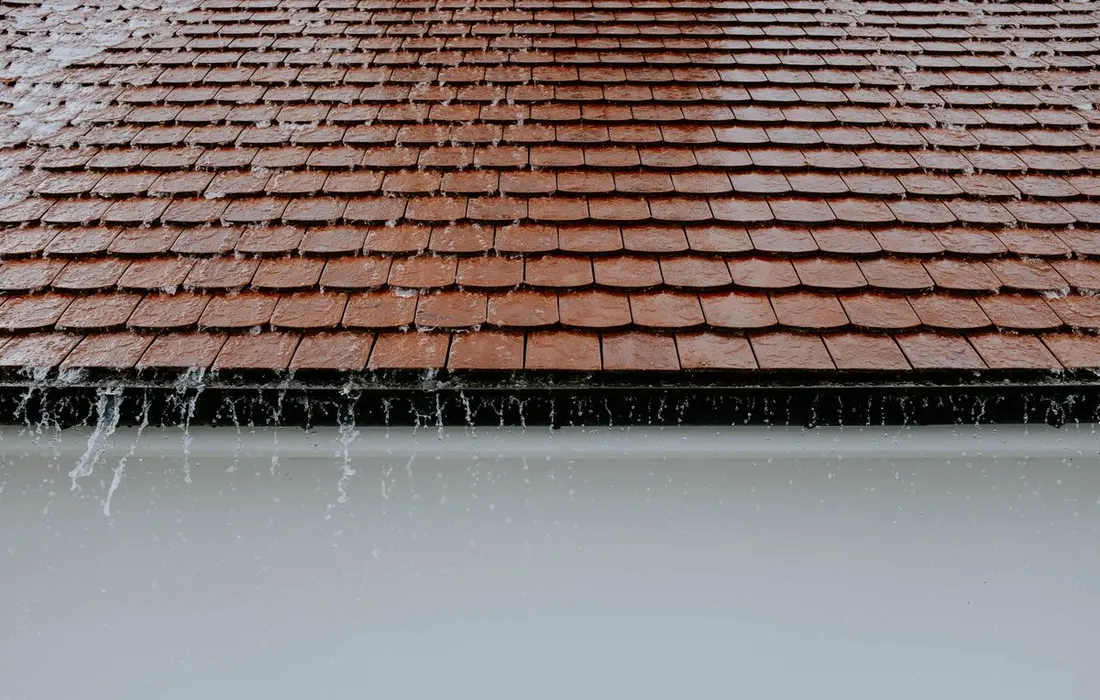 Rainwater running from a tiled roof.
