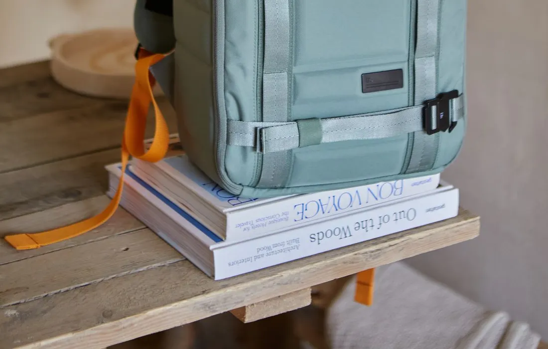 A backpack standing on a wooden table indoors.