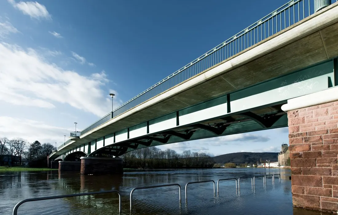 Idyllic view of a bridge spanning the Weser River in Holzminden, Germany, during daytime.