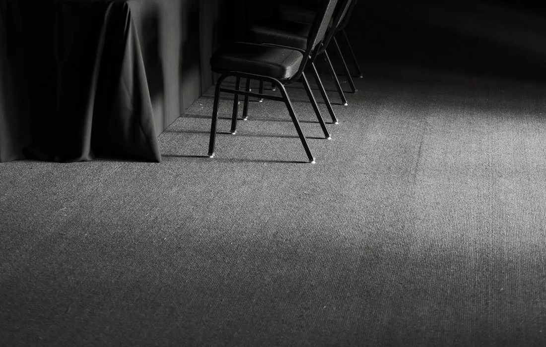 An empty meeting table with chairs arranged around it.