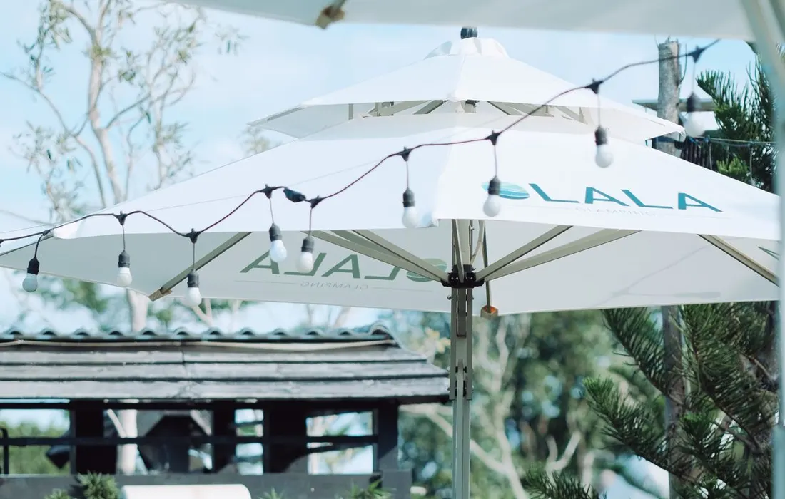 Garden chairs, a table and a parasol on an outdoor patio.