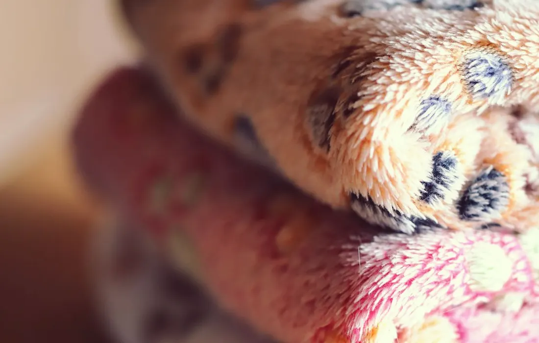 Comfortable stack of warm, patterned wool blankets. Perfect for cozy spaces.