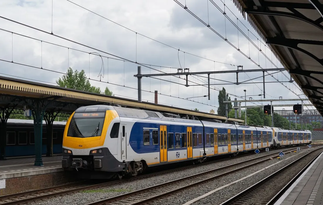 A train beside a quiet station platform.