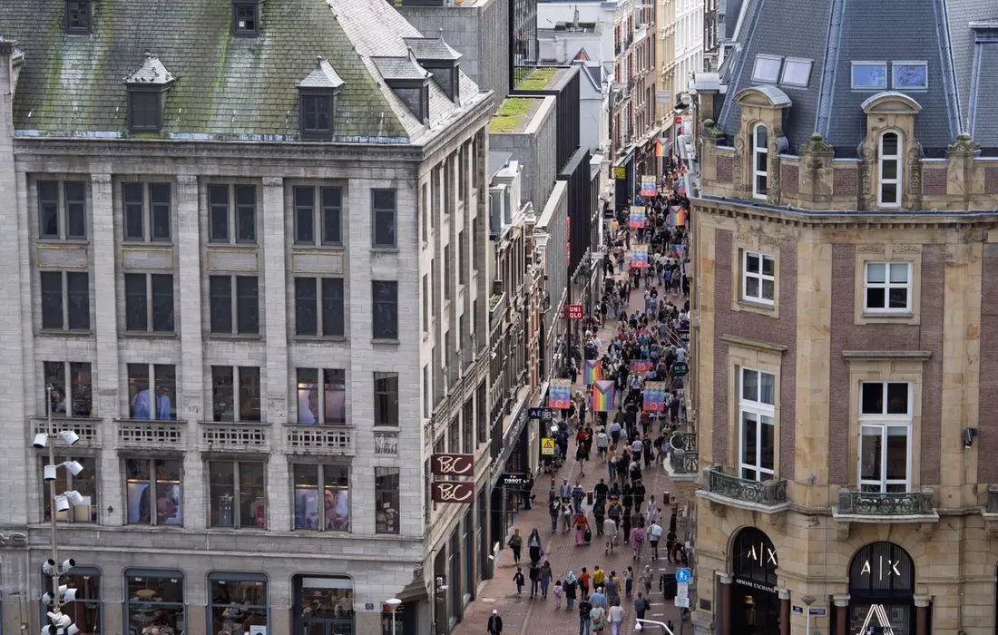 An aerial view of a pedestrian street between historic buildings.