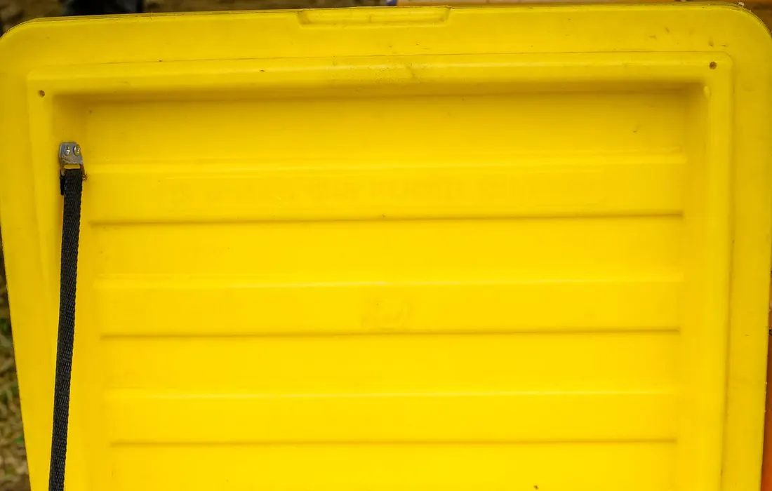 Bottled water arranged in a yellow cooler.