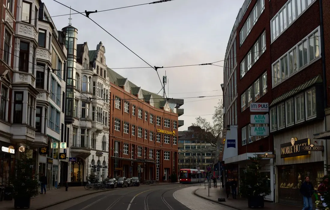 Tram rails between historic European buildings.