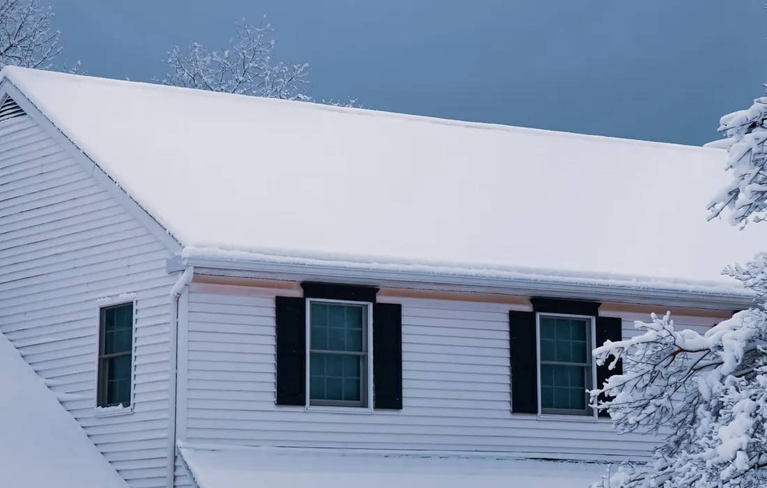 A charming suburban house blanketed in fresh snowfall during winter.