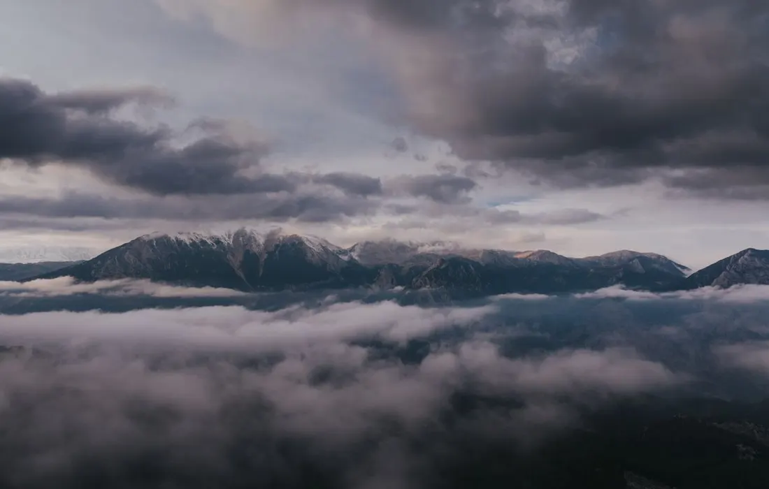 Cloud and mist above a mountain landscape.