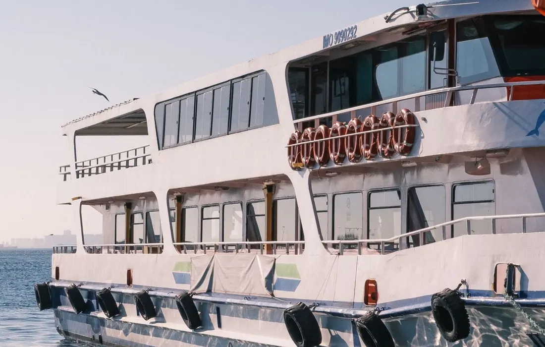A white passenger ferry moored in a harbour.