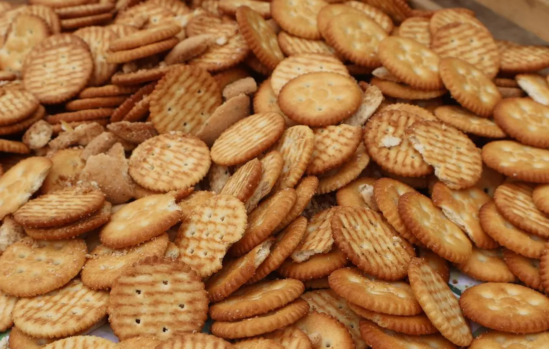 A selection of round crackers arranged in a pile.