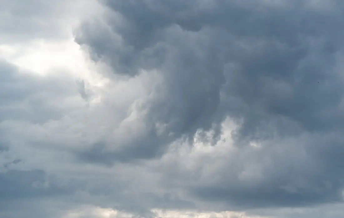 Layered grey clouds gathering in the sky.