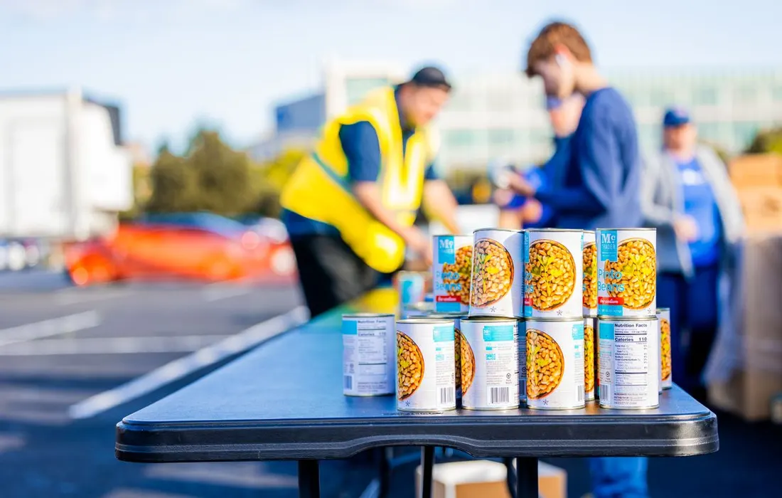 Tinned foods arranged on an outdoor distribution table.