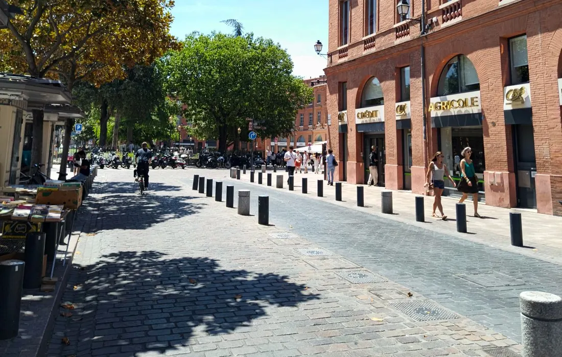 Historic buildings along a sunny European city street.