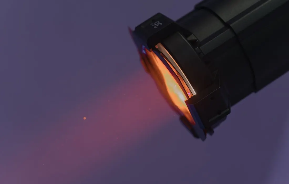A close-up of an electric torch shining in darkness.