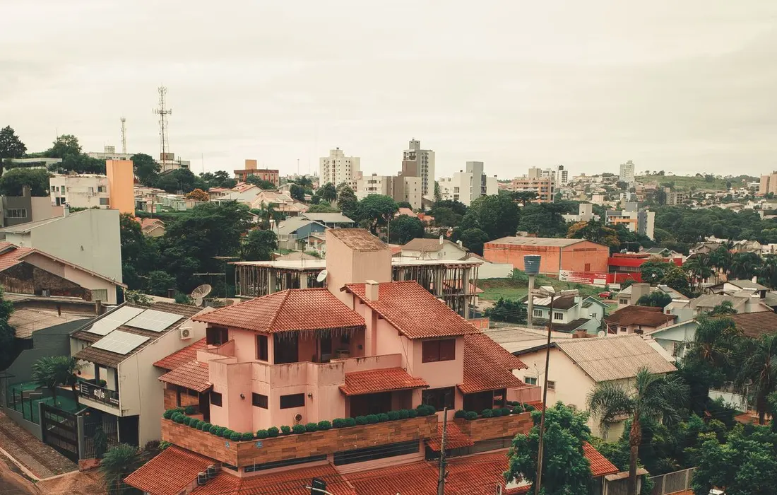 Residential roads and houses beneath an overcast sky.