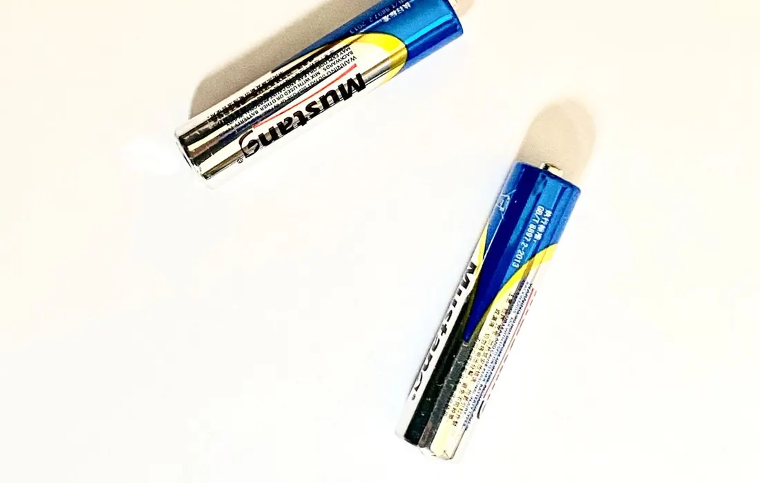 Two AA batteries on a white background.