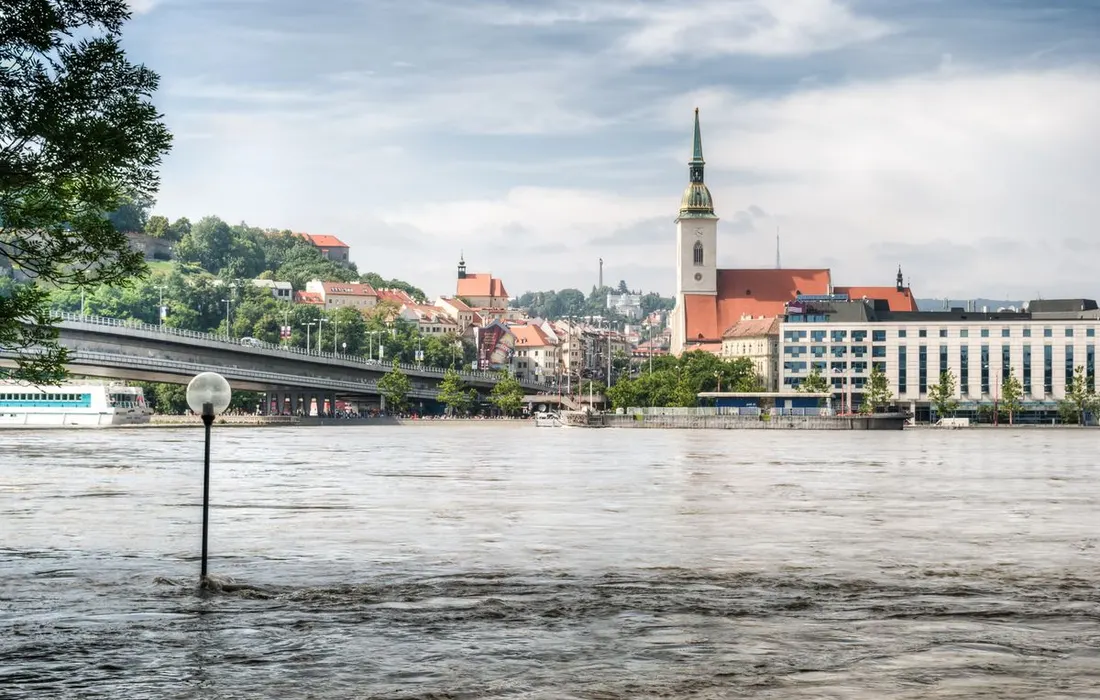 View of Bratislava cityscape during a high water level in the Danube River, highlighting the picturesque skyline.