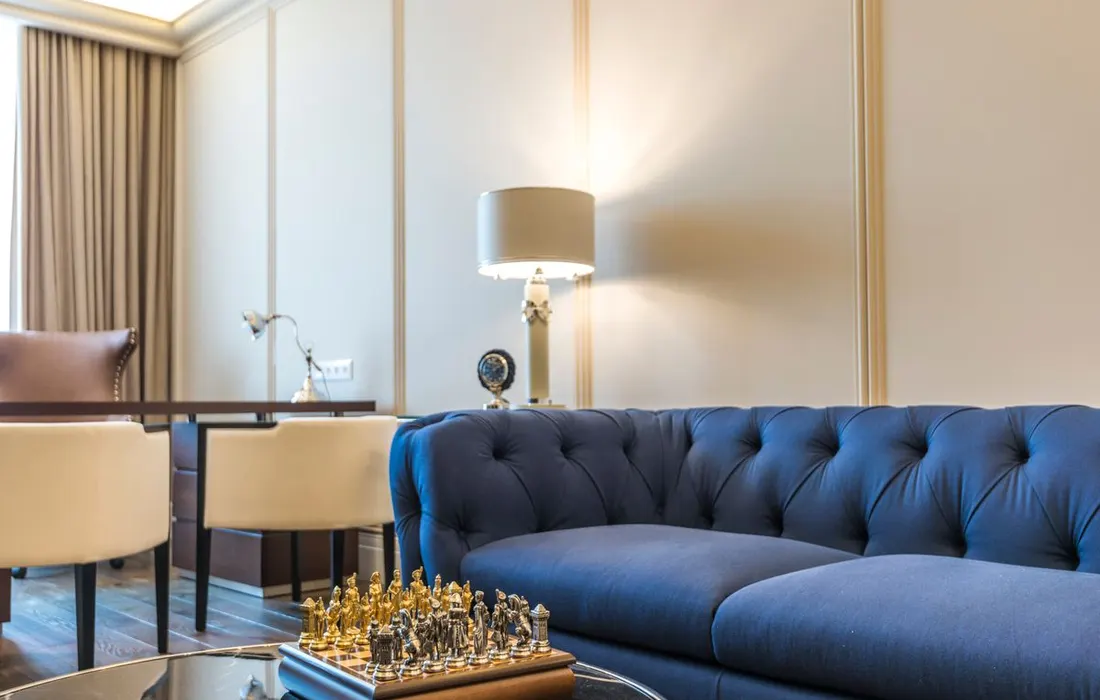 A blue sofa and side table in a furnished living room.