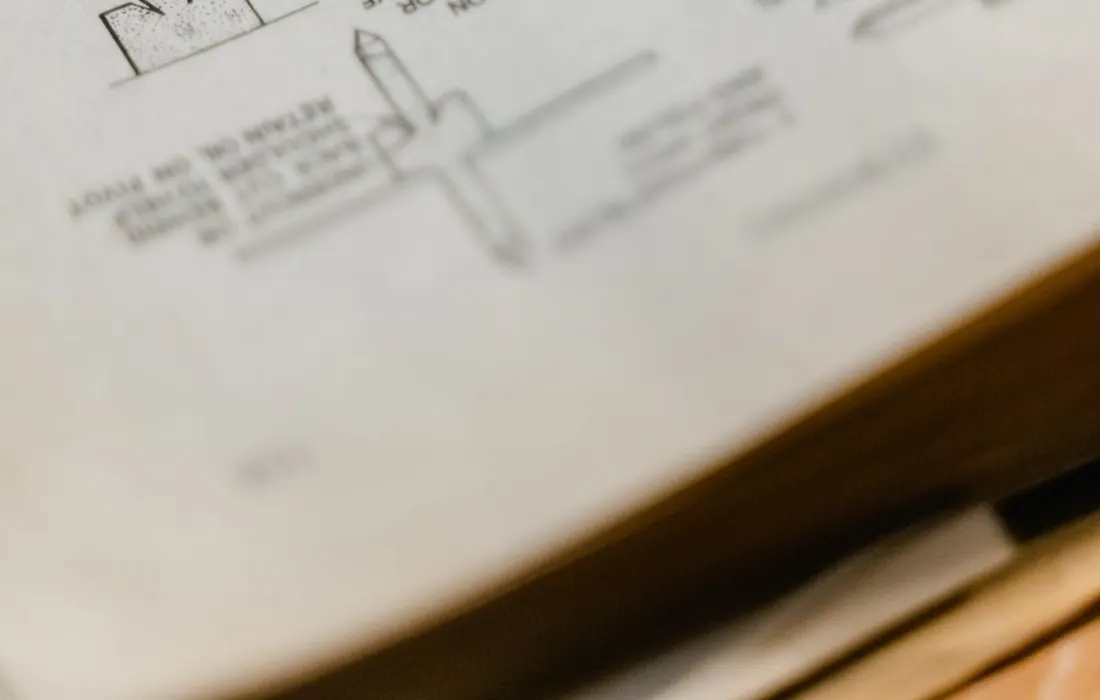 An open book displaying technical diagrams and printed text.