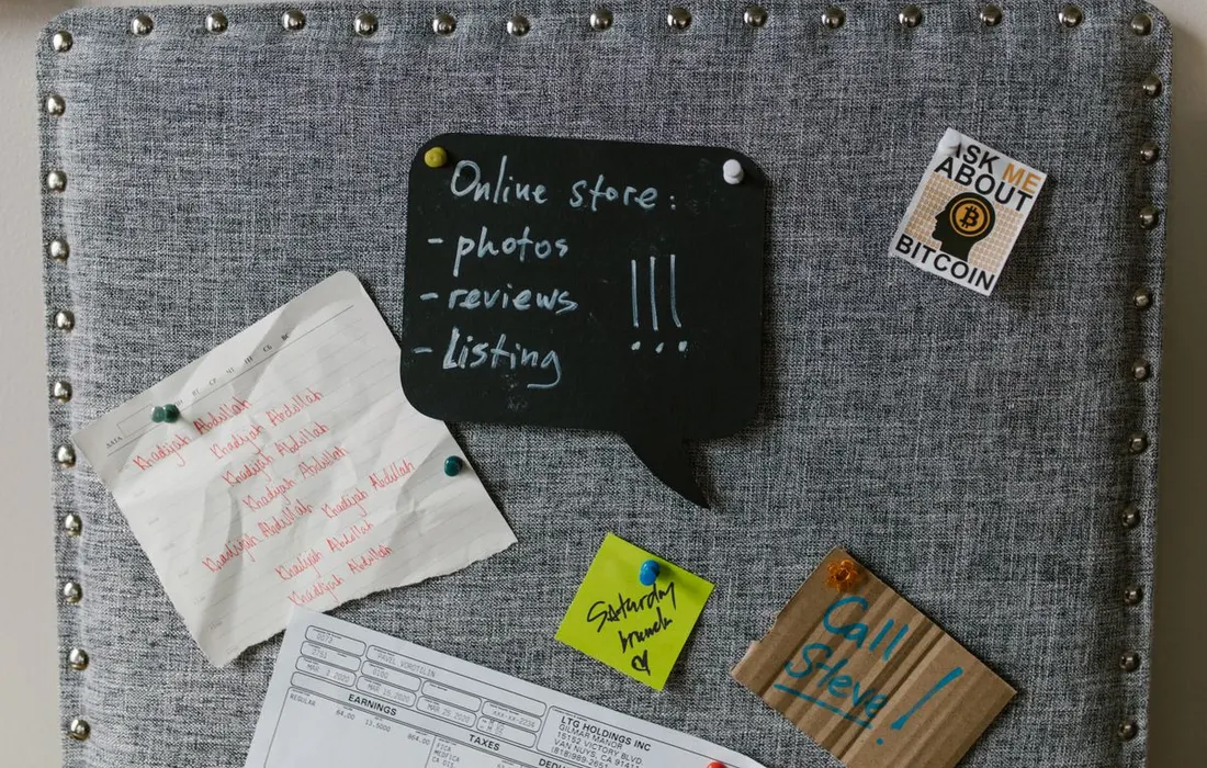Written notes and reminders attached to a noticeboard.