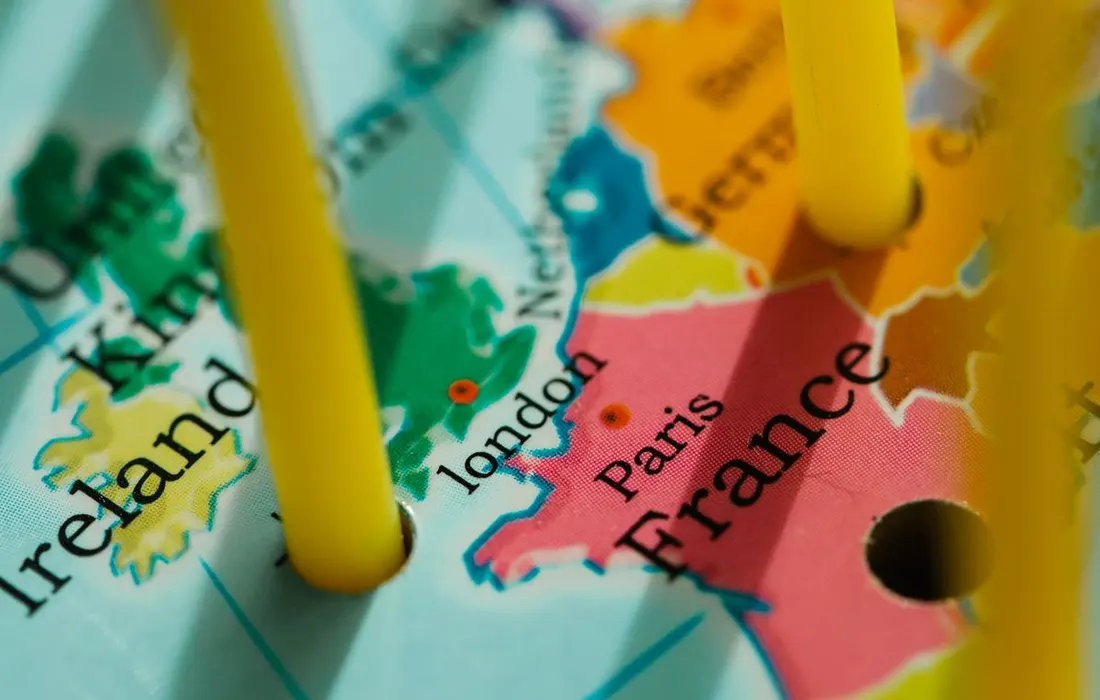 A paper map of Europe marked with small pegs.