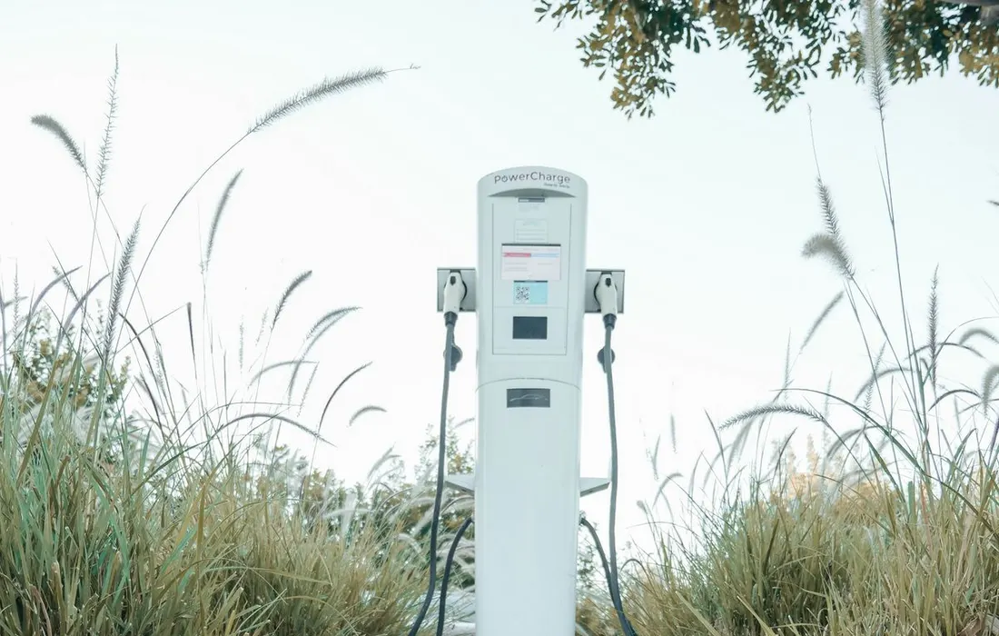 Electric vehicle charging equipment in an outdoor parking area.